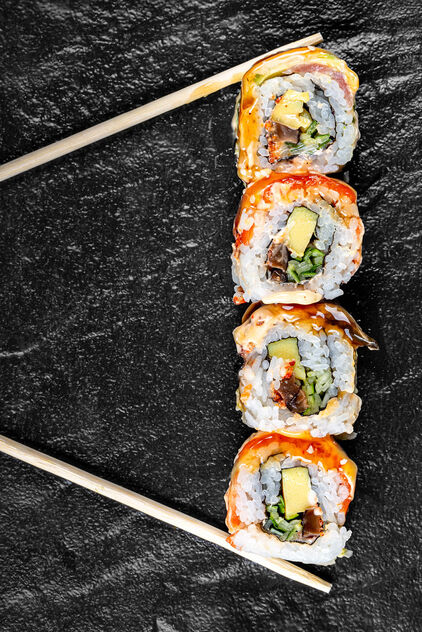 Sushi Rainbow Dragon on a black background with chopsticks - Free image #471989